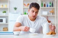 The man falling asleep during his breakfast after overtime work Royalty Free Stock Photo