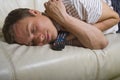 Man falling asleep with TV remote control Royalty Free Stock Photo