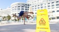 Man falling near yellow plastic sign caution wet floor closeup