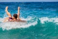 Man falling off inflatable ring while playing in ocean waves. Fun, energetic beach moment captured mid-splash. Ideal for summer Royalty Free Stock Photo
