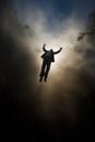 a man falling from the sky. floating in the heavens. flying in the clouds. free man. businessman with his arms raised. Royalty Free Stock Photo