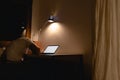 Man falls asleep while doing work on the desk with a laptop at night. Royalty Free Stock Photo