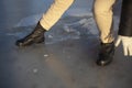 The man falls into the ice. The girl falls on the ice. Black army boots on a woman. Slipped in the street. Royalty Free Stock Photo