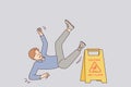 Man falls near warning sign with words caution wet floor due to negligence and inattention Royalty Free Stock Photo