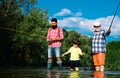 Man family fishing. Boy with father and grandfather fly fishing outdoor over river background. Old and young. Father and Royalty Free Stock Photo