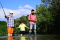 Man family fishing. Boy with father and grandfather fly fishing outdoor over river background. Old and young. Father and Royalty Free Stock Photo