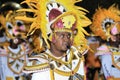 man in a fancy costume is singing into a microphone while holding a cigar