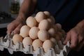 A man farmer holding a tray full of chicken eggs from the farm Royalty Free Stock Photo