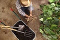 Man farmer working in vegetable garden, wheelbarrow full of fer