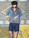 Man, fashion and casual with sunglasses, cool and outdoor in urban area, city and europe. Fashionable, painting and