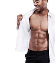 Man, fashion and happy with abs, sexy and dressing for chest, african and male model in white background. Alone, smile Royalty Free Stock Photo