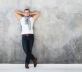 Man, fashion model posing in white t-shirt in jeans in full length Royalty Free Stock Photo