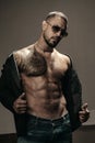 Man fashion undress. Bearded male with abs and sunglasses. Trend style macho in casual style clothes. Confidence and