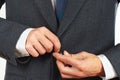 Man fastened the buttons on his business suit closeup