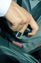 Man fastening the car safety belt