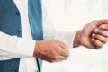 The man fastens the buttons on the shirt. Morning of the groom. Hands of wedding groom buttoning up his white shirt Royalty Free Stock Photo