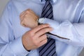 Man fastens his cuff links close-up Royalty Free Stock Photo