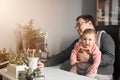 Man father with baby in carrier working at office or home with computer at the desk, parent in office Royalty Free Stock Photo