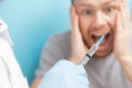 Man is fear and cries from syringe with vaccination doctor appointment. Concept trypanophobia Royalty Free Stock Photo