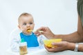 Man feeding baby with a spoon