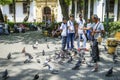 Cartagena, Colombia - April 10 2017: A man feeding birds in Cartagena Town Square While People Watching