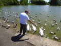 Man feeding birds in park