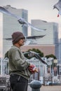 A man feeding a flock of seagulls in the Yokohama port. Birds in the city.