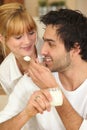 Man feeding his girlfriend Royalty Free Stock Photo