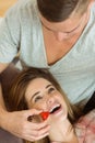 Man feeding his girlfriend a strawberry Royalty Free Stock Photo