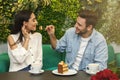 Man Feeding His Girlfriend Tasting Cake Sitting In Cafe Royalty Free Stock Photo