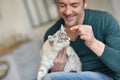 Man feeding little cat Royalty Free Stock Photo