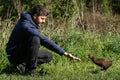 Man feeding weka bird, New Zealand flightless native bird