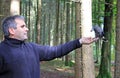 A man feeds a pine jay in the forest
