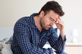 Depressed man portrait sitting on the bed Royalty Free Stock Photo