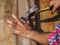 Man feeling his sore hand after having hurt himself while hammer Royalty Free Stock Photo