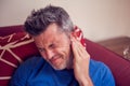 Man feels strong ear pain. People, healthcare and medicine concept