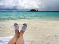 Man feet in beach slippers on a background of the beautiful sea Royalty Free Stock Photo