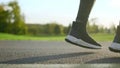 Man feet dancing on road. Active sportsman legs jumping in park.