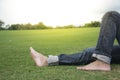 Man feet relaxing on grass enjoying in a day in a park with sky Royalty Free Stock Photo