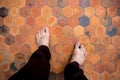 Man feet standing on the clay tiles
