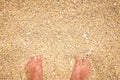 Man feet standing in sand