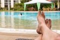 Man feet at swimming pool