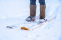 A man in felt boots on homemade skis walks through the snow into forest. Hiking, traveling, hunting, fishing.