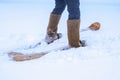 A man in felt boots on homemade skis walks through the snow into forest. Hiking, traveling, hunting, fishing. Royalty Free Stock Photo