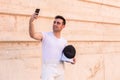 Man with fencing equipment taking a selfie