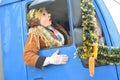 Man in a festive costume and mask in the car