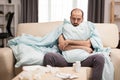 Man with fever wrapped on blanket