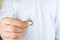 Engagement / marriage / wedding proposal scene. Close up of man handing the expensive gold platinum diamond ring to his bride. Royalty Free Stock Photo