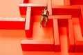 Man figurine and Red wooden labyrinth maze,  elevated high angle view Royalty Free Stock Photo