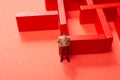 Man figurine and Red wooden labyrinth maze,  elevated high angle view Royalty Free Stock Photo